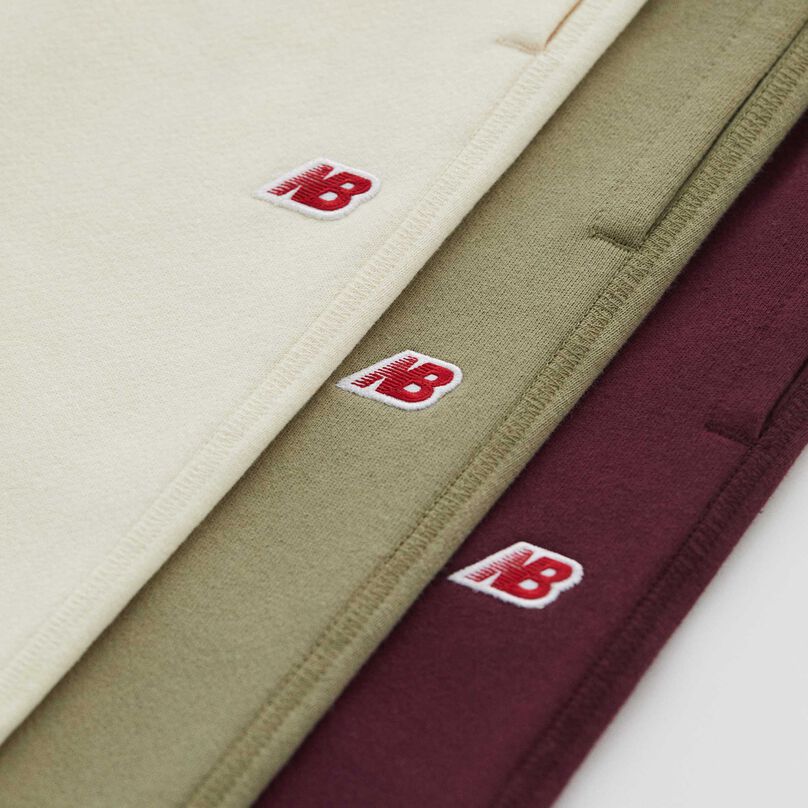 Three Made in USA sweatpants stacked on top of each other, each a different color.